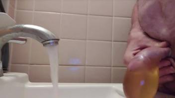 Filling a condom with piss